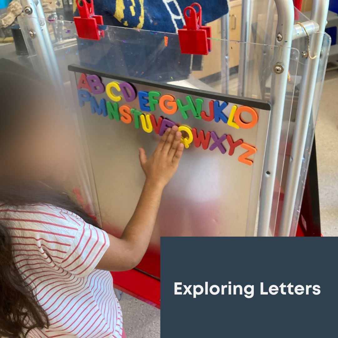 Children learning through play using magnetic letters 
